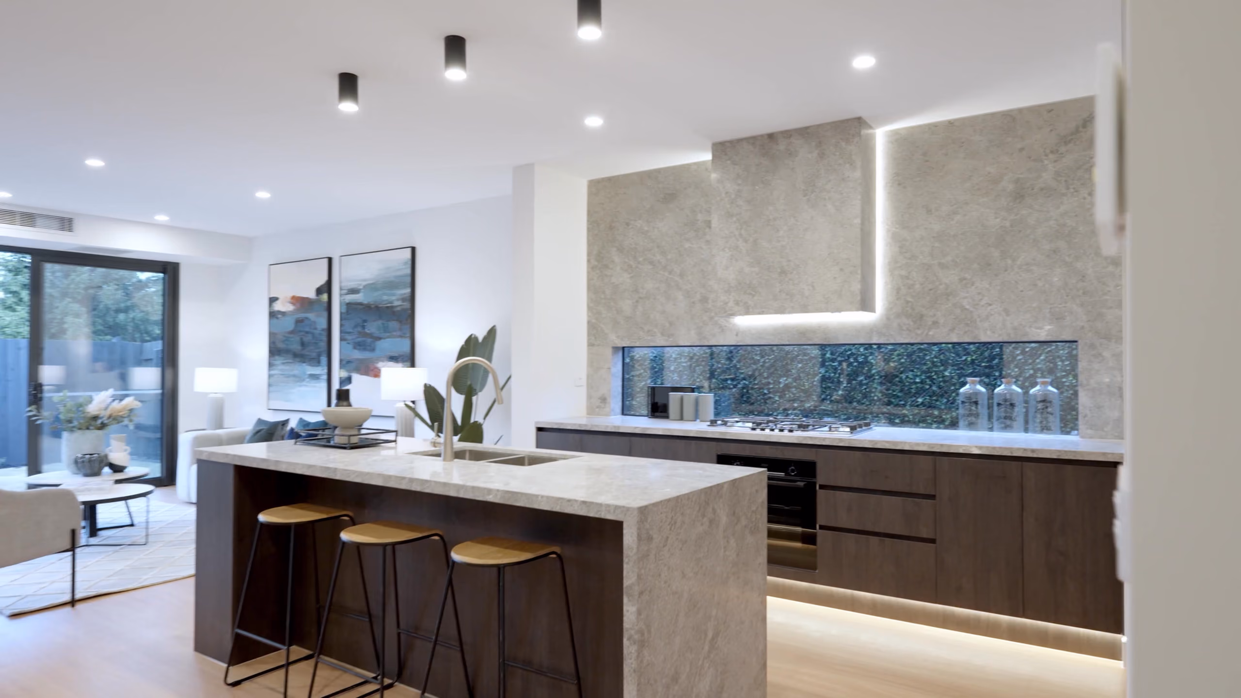 Longmere kitchen: stone island with timber cabinetry and a window splashback