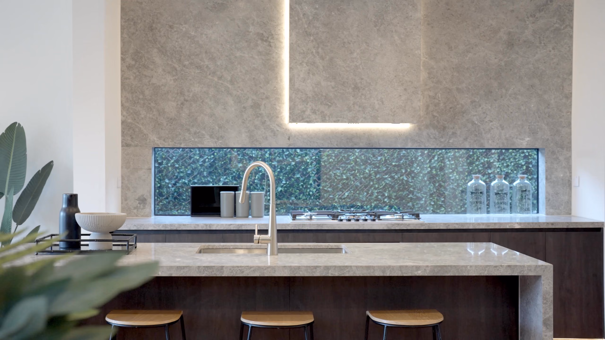 Longmere kitchen bench with a rendered feature wall and concealed lighting