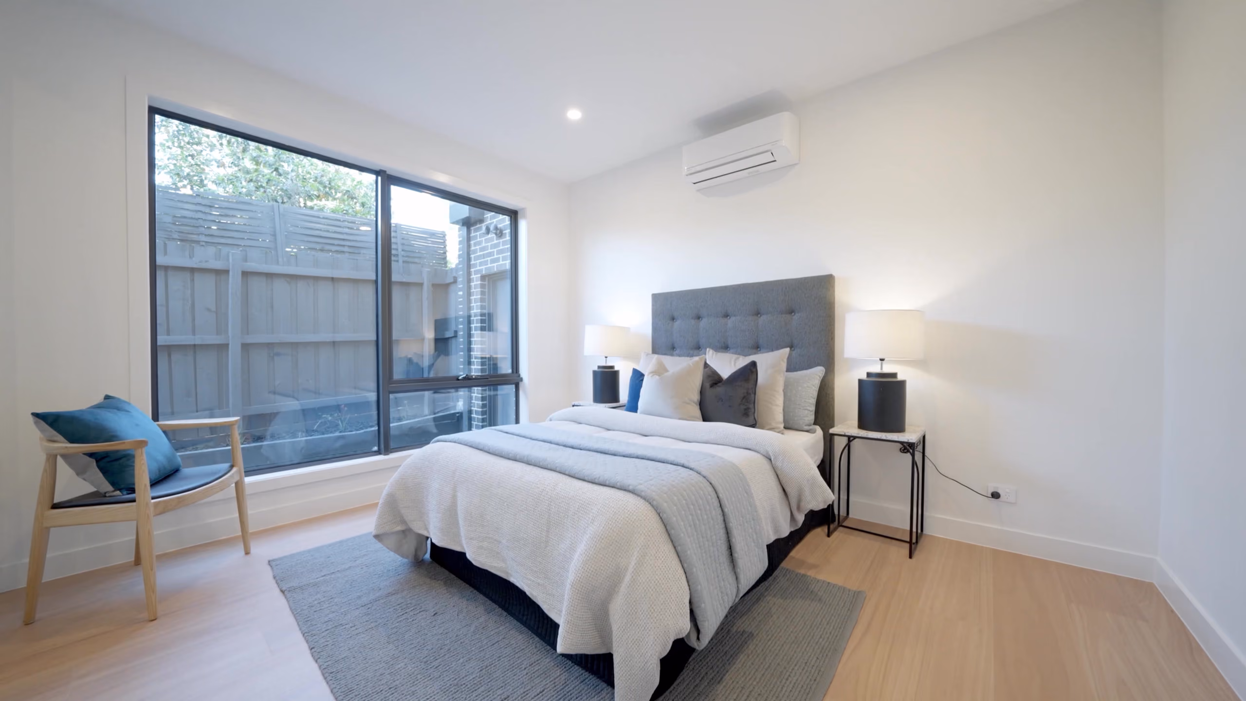Longmere bedroom with a full-height window to the garden