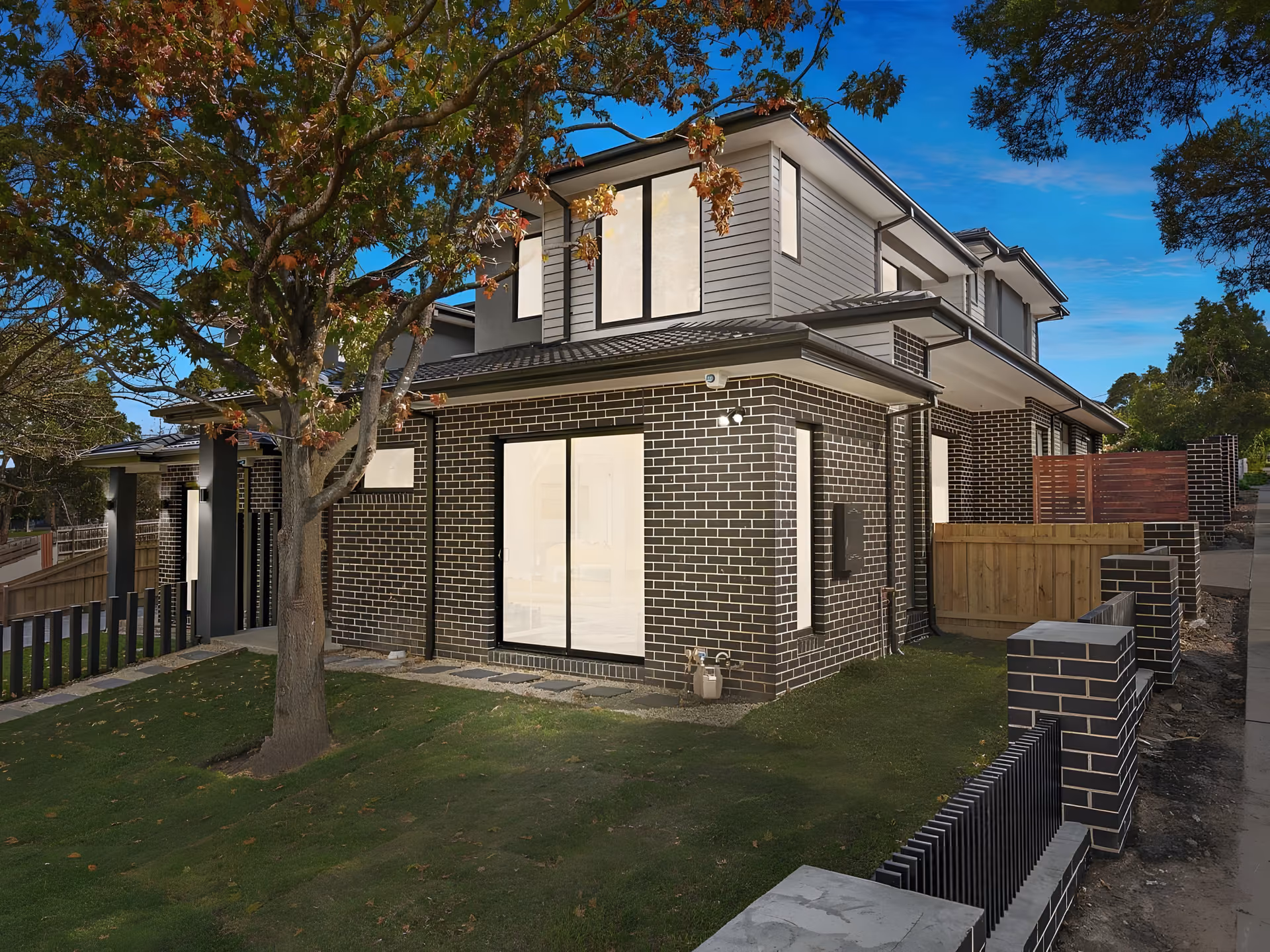 Elmhurst Road brick townhouse under a mature tree