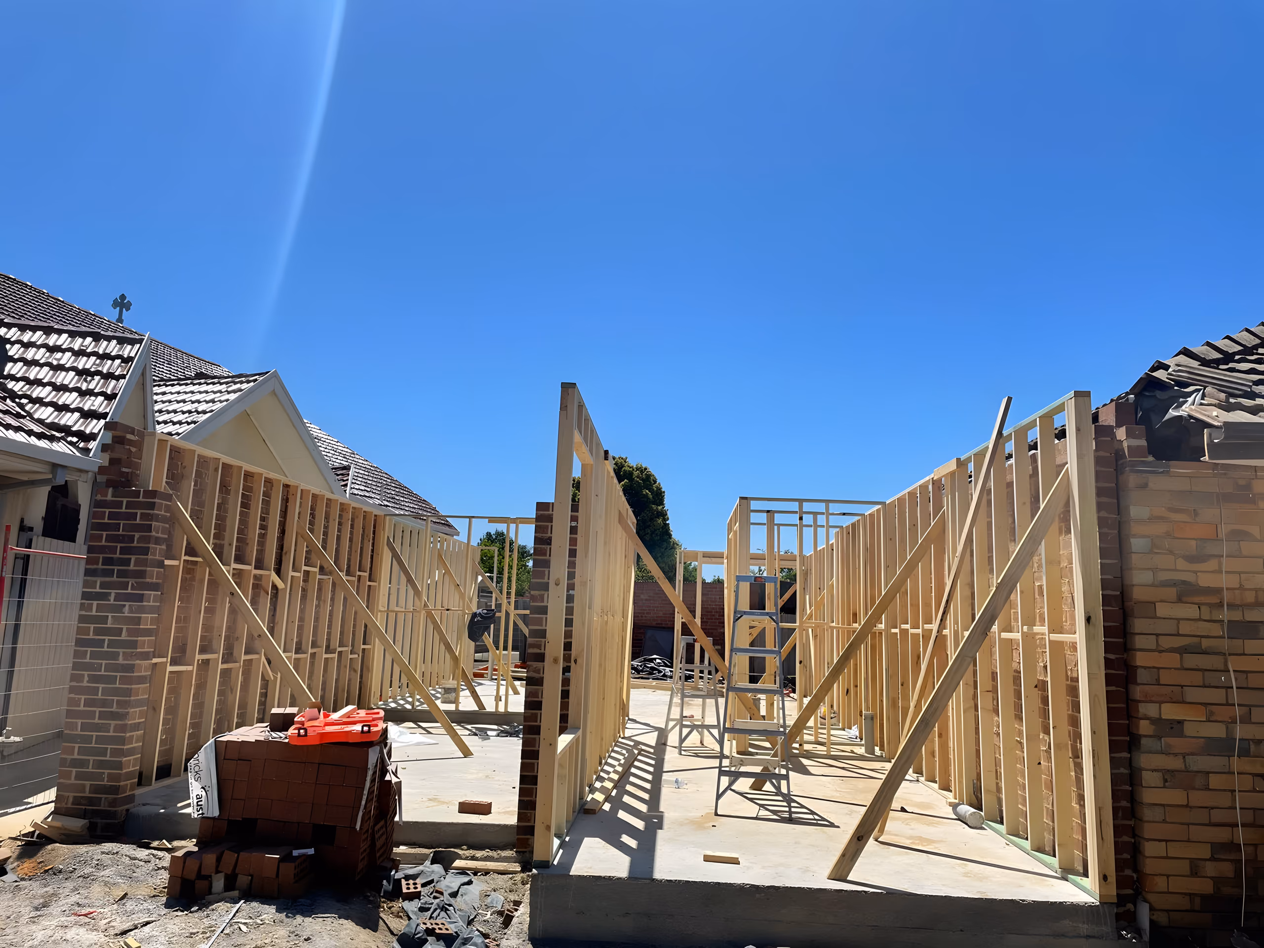 Eve Court townhouse framing rising beside the existing house