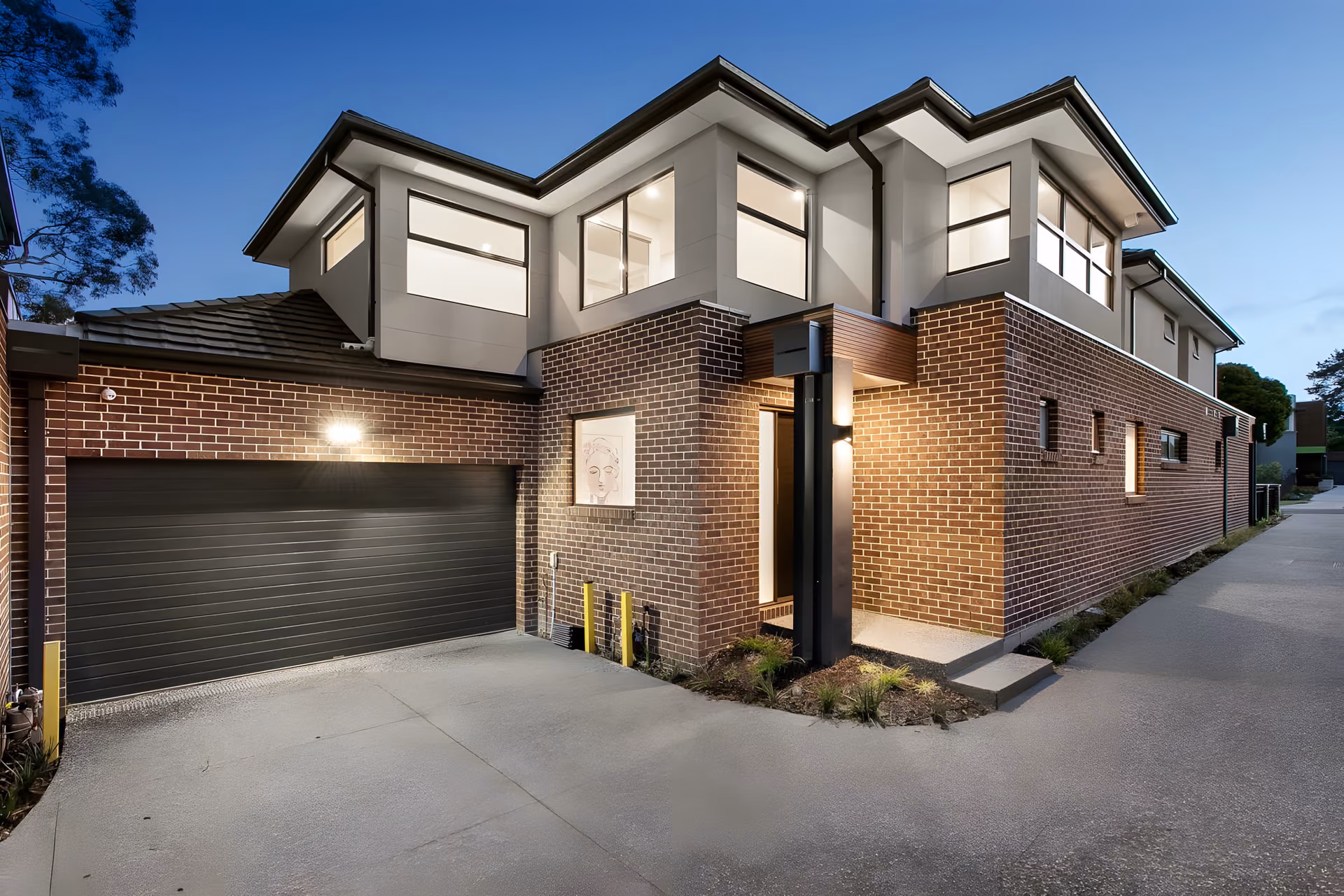 Summit Road townhouse entry and garage at dusk